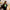 Woman holding a green Era 30oz straw tumbler indoors