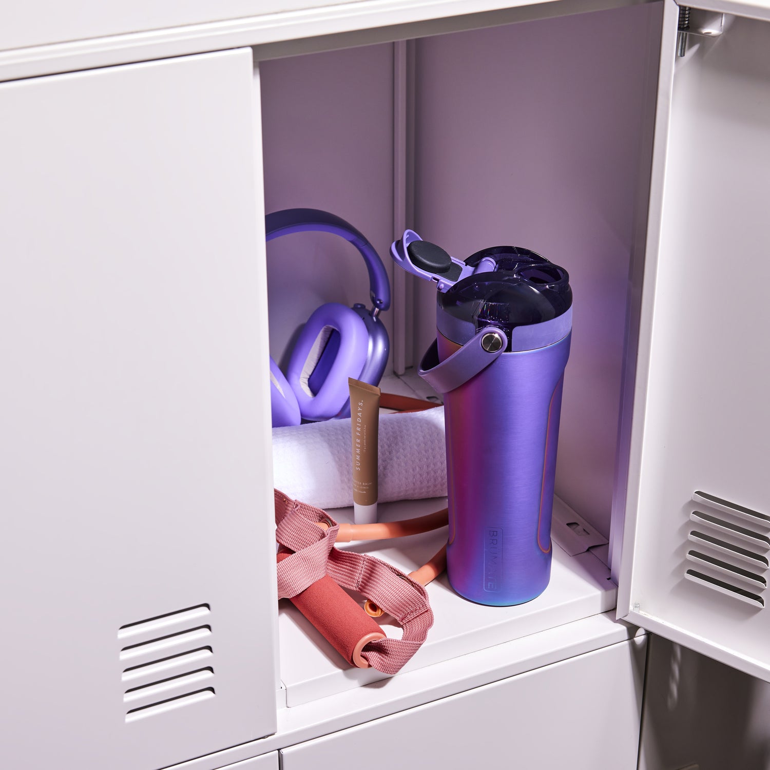 Gradient purple MultiShaker 25oz Fitness Shaker and exercise band inside a locker with purple interior.