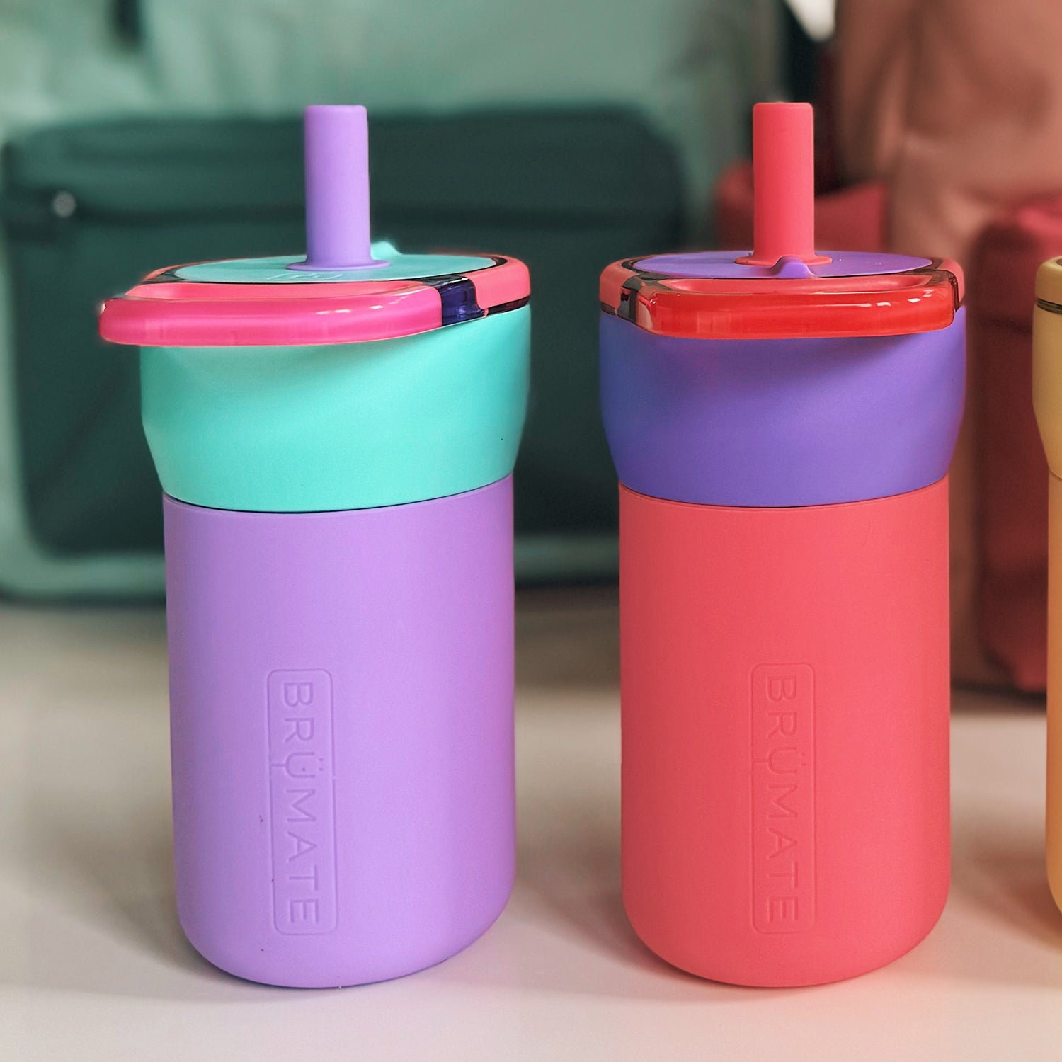 Two colourful Leap 12oz tumblers with straws on a surface, featuring the BruMate brand.