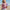 Young girl holding a purple and pink Leap 12oz tumbler on a beach